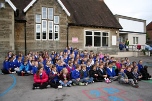 Wincanton Primary School children sitting out on the playground