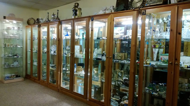 Antiques in cabinets at Past Times, Wincanton High Street