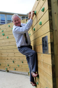 Wincanton Mayor, Cllr Deryck Lemon, traversing the new climbing wall at King Arthur's School