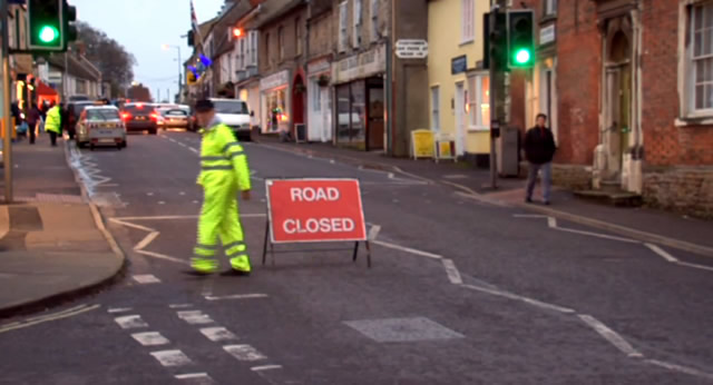 A steward setting up the 'Road Closed' sign for last year's Extravaganza
