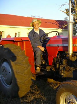 Canon Jesse Sage riding a tractor