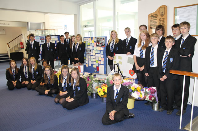 King Arthur's students gathered around a tribute to David Kiddell