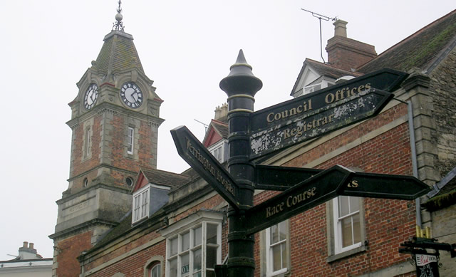 The Wincanton Town Hall clock tower, and the Market Place signpost