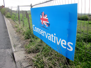 The Conservatives sign attached to the security fence at the Bayford Hill development site