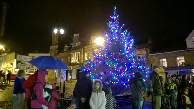 People gathered to enjoy the tree and listen to the carol singers