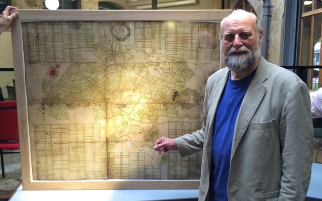 Photo by Joss Mullinger: Prof. Will Vaughan standing with the oldest known map of Castle Cary and Ansford