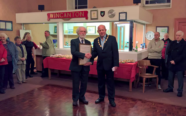 Colin Winder being presented the Wincanton Town Council's Community Award for 2016 by Mayor Howard Ellard