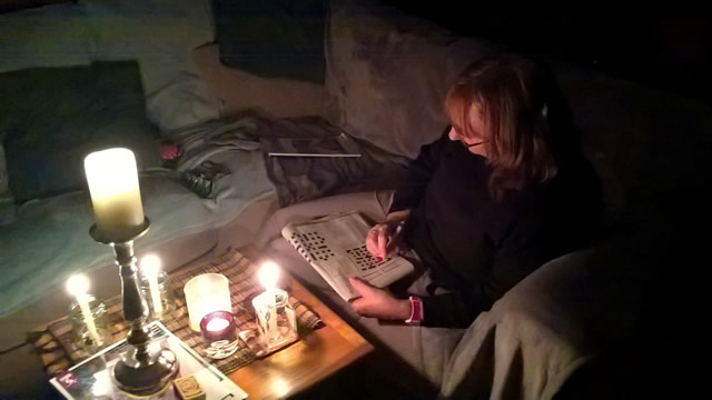 Doing a crossword by candellight during Wincanton's two-hour power cut