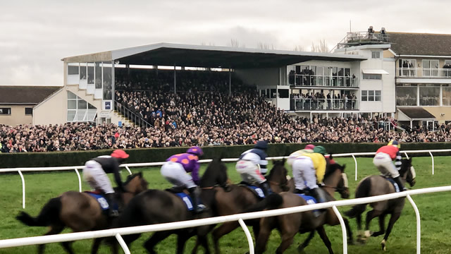 Racers passing by the grandstand at Wincanton Racecourse