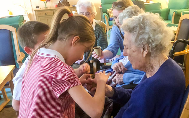 Our Lady's pupils potting plants with residents of Carrington House, Wincanton