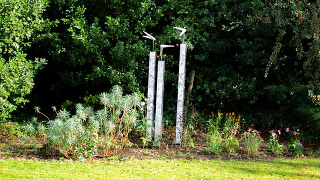 A wind-reactive pillar sculpture in the garden of the Greening the Earth gallery in Wincanton