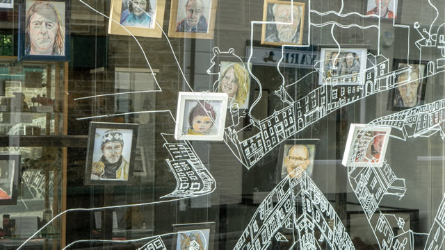 Portraits of local people in the window of the Greening the Earth gallery, Wincanton