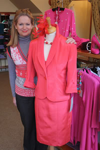Juliet Lake in her shop, Preview, with a pink ladies suit