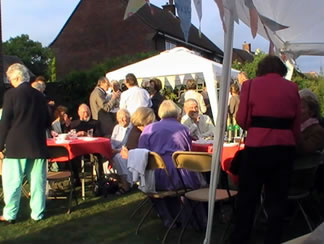 People gathered outside by the tent