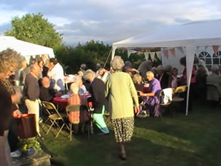 More people gathered by the marquee