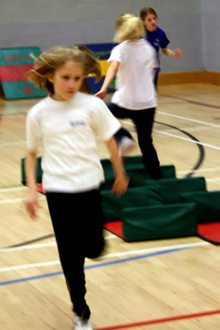 Girls racing through an obstacle course