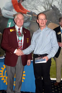 Stan Jones (District Governor) presents the Rotary Pin to Simon Jones (President)