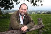 David Heath MP, leaning rather heavilly on a rickety old fence.