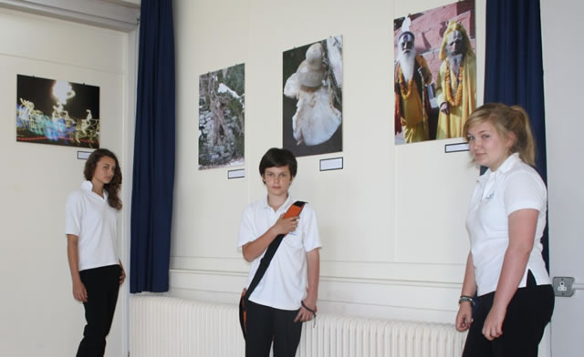 Three of the photographers, Julia Blackmore, Harry Russell and Lauren Feast, standing near the gallery