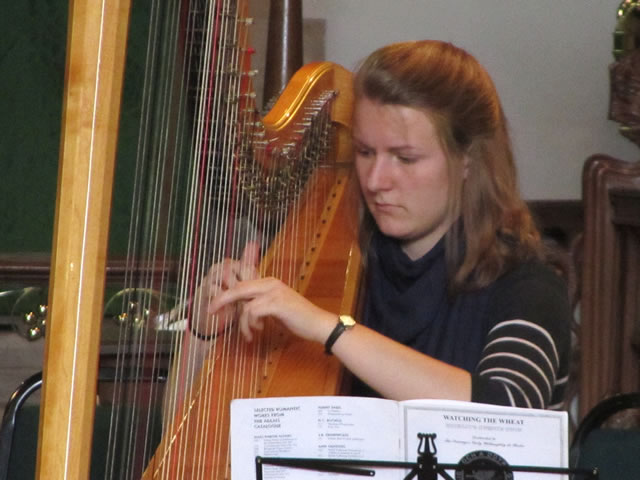 Madelaine Kirby playing the Harp