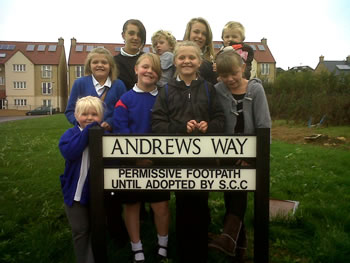 Local kids gathered around the sign for the New Barns path, Andrews Way