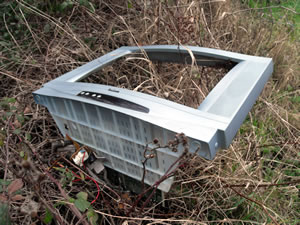 Bits of a smashed TV thrown into the overgrowth of the riverbanks of the Cale at Shadwell Lane