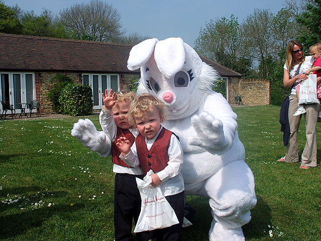 The Easter Bunny presents a prize to the best dressed egg hunters.