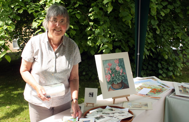 Artist Sheila Watkins with her paintings