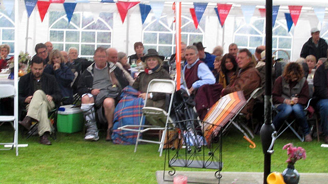 The audience sat under shelter with their picnics