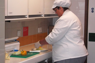 A Wincanton Community Hospital cook, preparing a salad