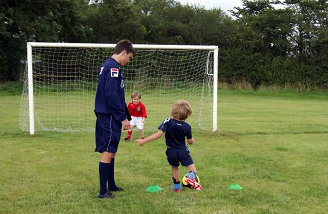 Young soccer players being coached