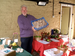 Stallholder holding up a tray of mushrooms