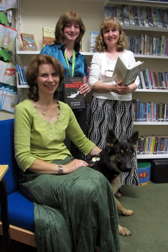 Crime author Lyndon Stacey with her German Shepherd puppy, Shia, and Wincanton Library staff