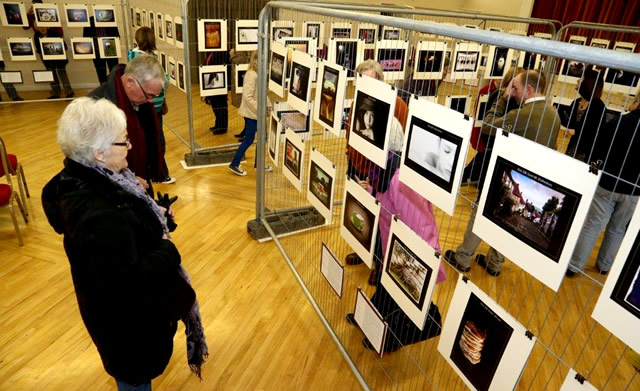 People enjoying Trixie Hiscock's 365 Project exhibition in Wincanton Memorial Hall