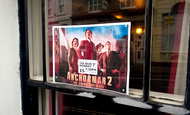 Wincanton Film Societ's Anchorman 2 poster, stuck in a window at The Bear