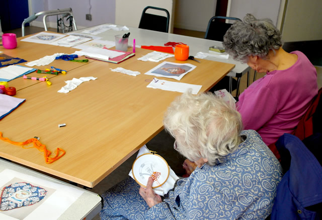Carrington House residents doing embroidery