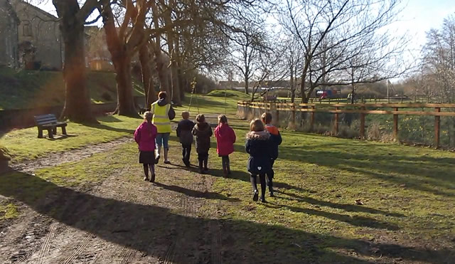 School children carrying saplings to the planting site