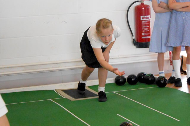 A Wincanton Primary School girl playing short mat bowls