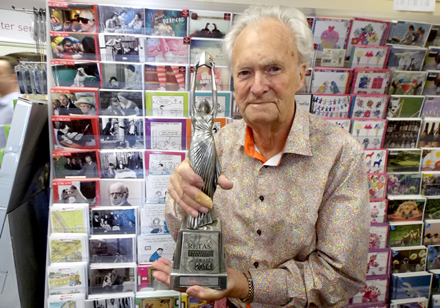 Malcolm McCormack holding his 2014 RETAS trophy