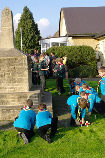 Brownies, Guides and Cubs placing crosses at the Wincanton Memorial Hall memorial