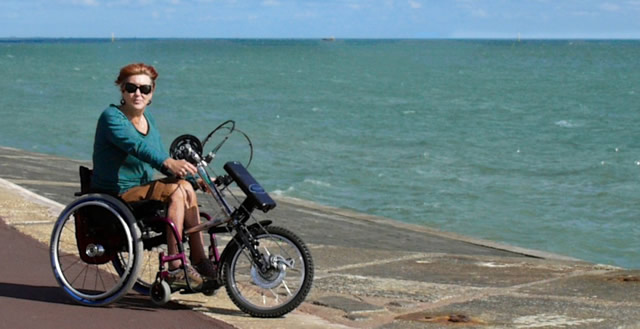 Laura Collinson and her powered cycle, perfect for life outdoors
