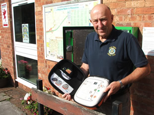 Roger Lowe, Brue Valley Community Rep, holding the opened defibrillator pouch