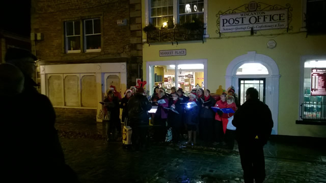 The Choir Wincanton carol singing near the tree