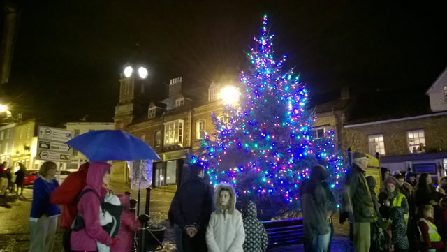 People gathered to enjoy the tree and listen to the carol singers