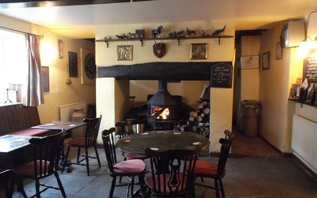 The tables and wood burner at The Unicorn, Bayford