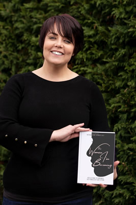 Michaela Pay holding a copy of The Woman I'm Becoming, to which she has contributed a chapter