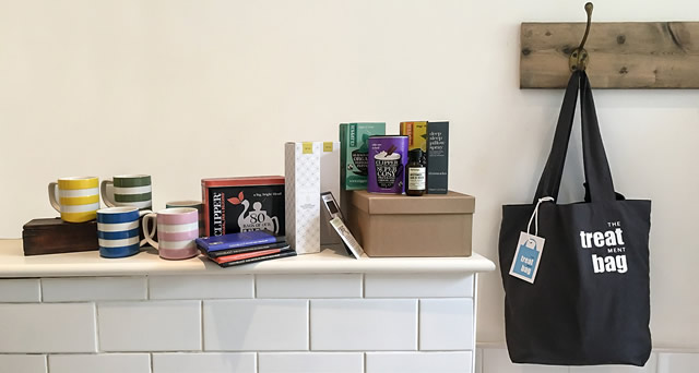 A Treatment Bag hanging on a hook, with its contents displayed on a mantelpiece