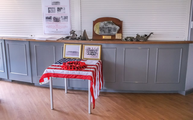 A display of artifacts and photos at the Old Faithful 75th anniversary memorial service