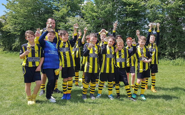 Wincanton Warriors Under-12s team holding trophies