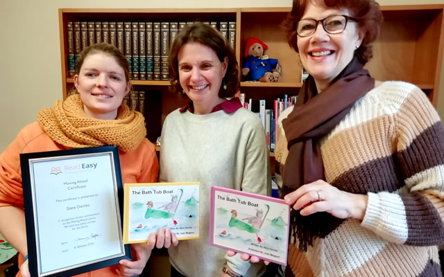 Sara Davies, former Read Easy learner from Wincanton, with her coaches Hannah and Hilary holding the book she has written for her children